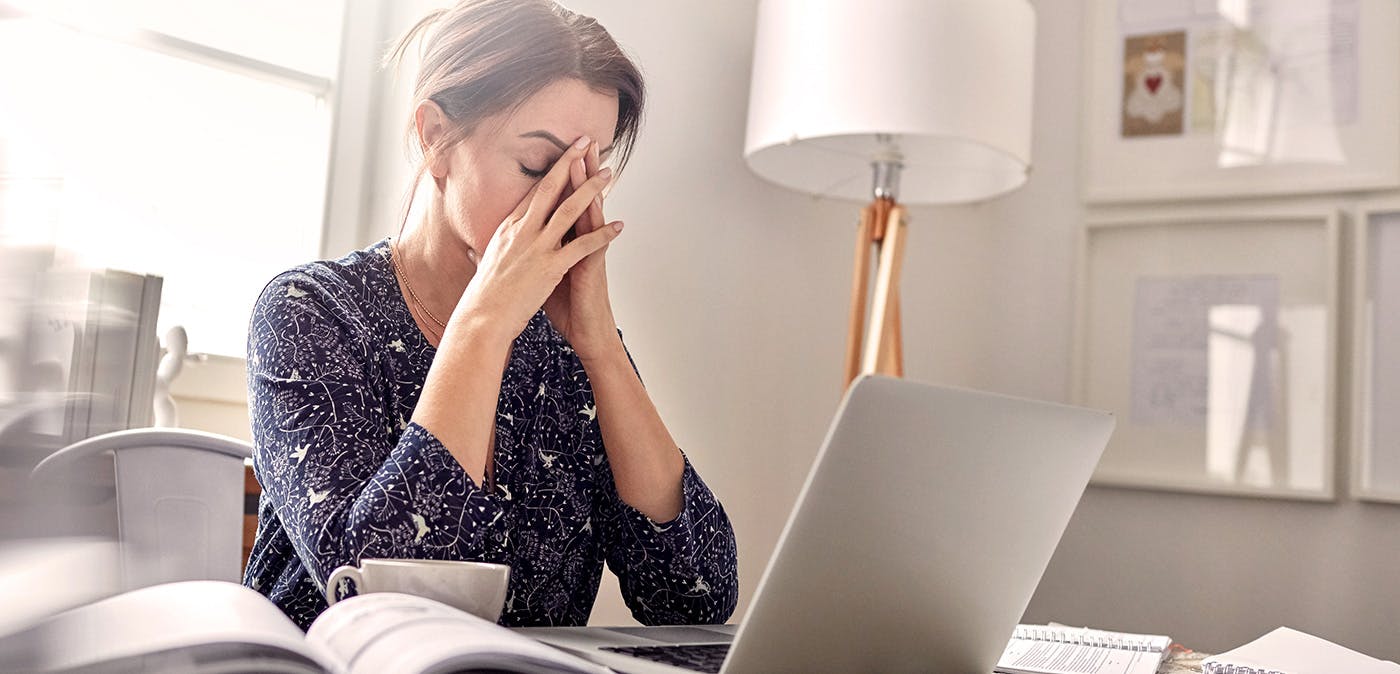 Stressed woman sitting at computer