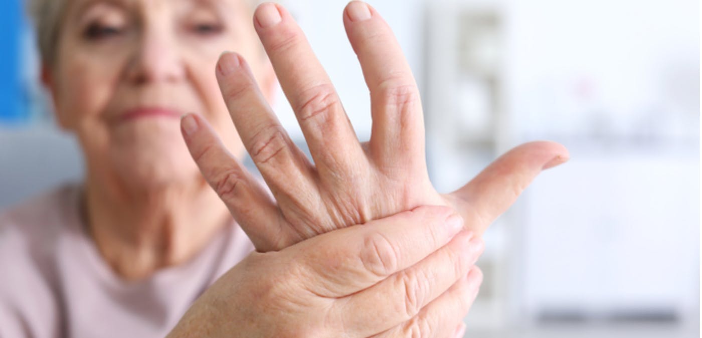 Elderly woman suffering from hand pain