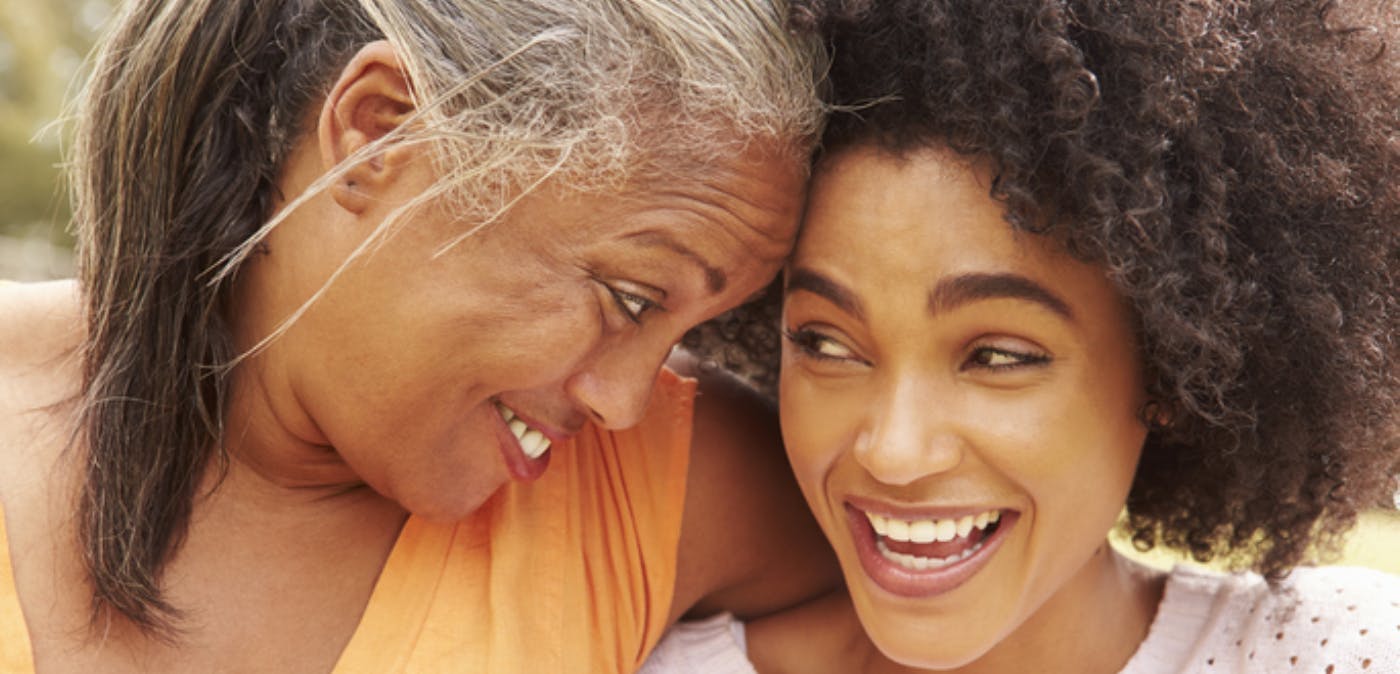 Older Black mother looking at adult daughter