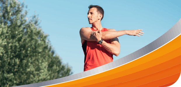 Man stretching his shoulders outdoors