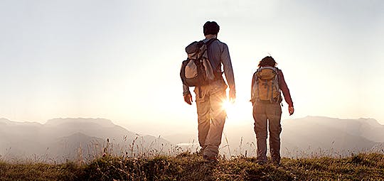 A couple of backpackers walking on a trail