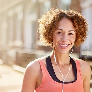 Woman smiling and listening to music with headphones