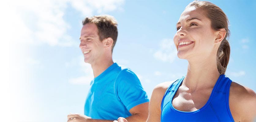 Young man and young woman jogging outside