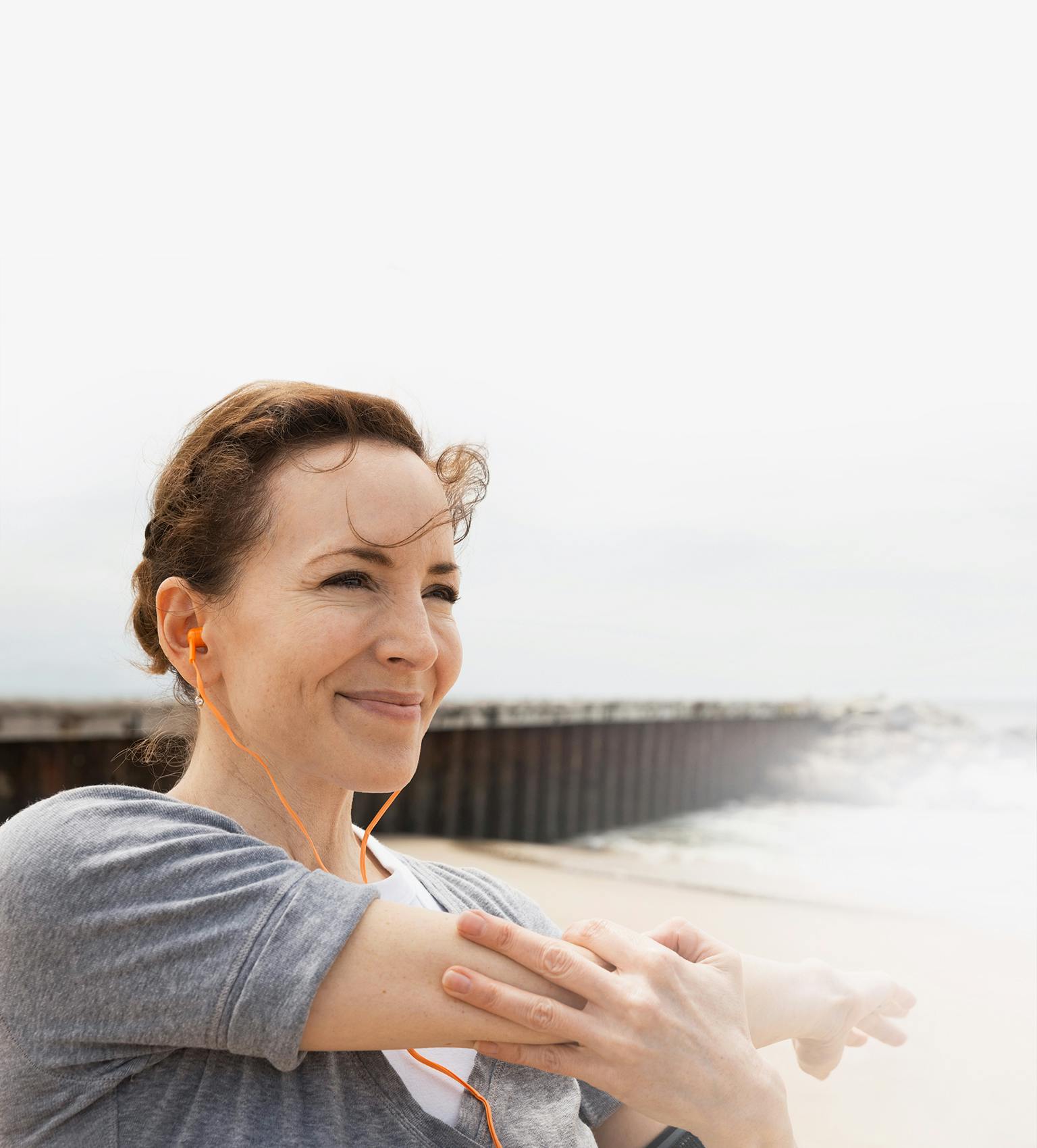Young woman stretching her arm before excercising