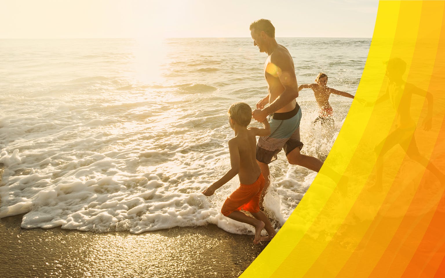 Happy young family running into water at the beach