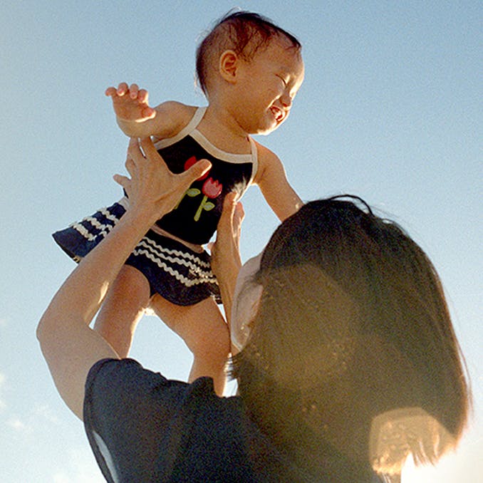 Mother lifting baby