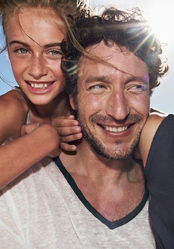 Photograph taken of father and daughter smiling