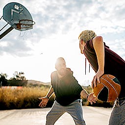 Photograph of two men playing basketball