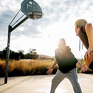 Photograph of two men playing basketball