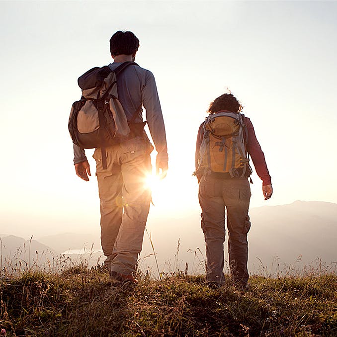 Photograph of two people hiking