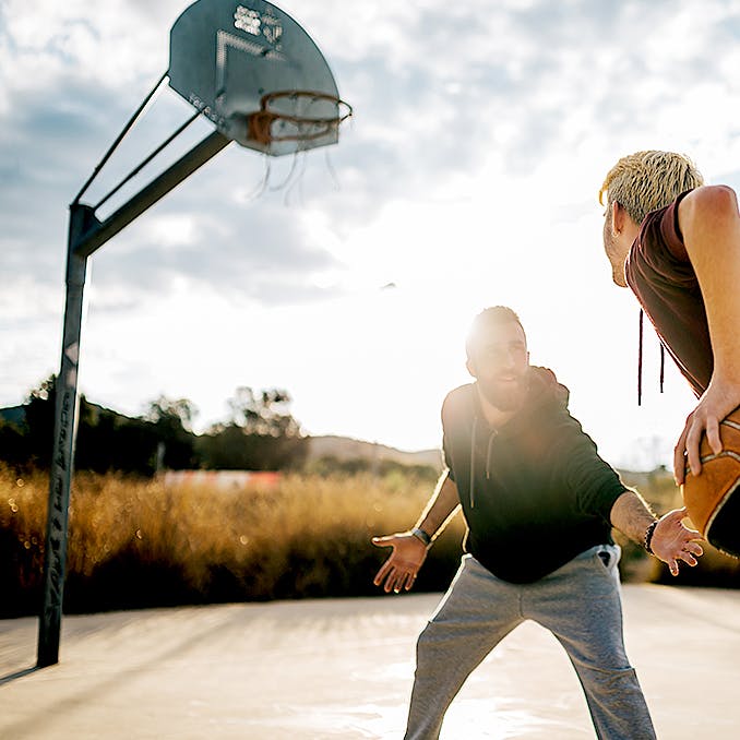 Photograph of two men playing basketball