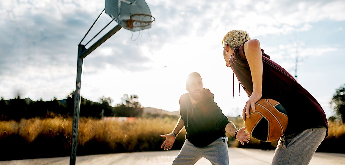 Photograph of two men playing basketball