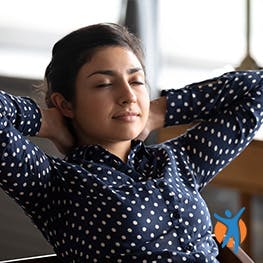 Woman sitting relaxed with her hand behind her head