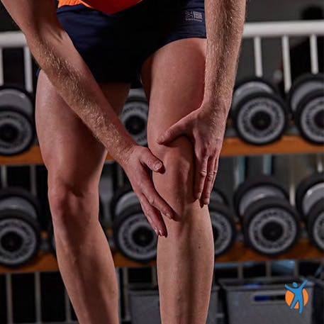 Man clutching kneee - learn how to avoid pain in knee joints