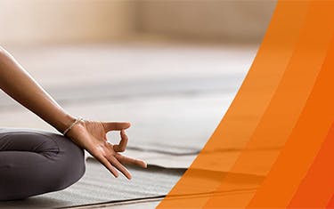 Close up of a woman in seated yoga pose for relieving back pain