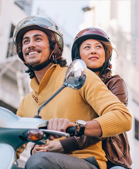 photo of man and woman on scooter
