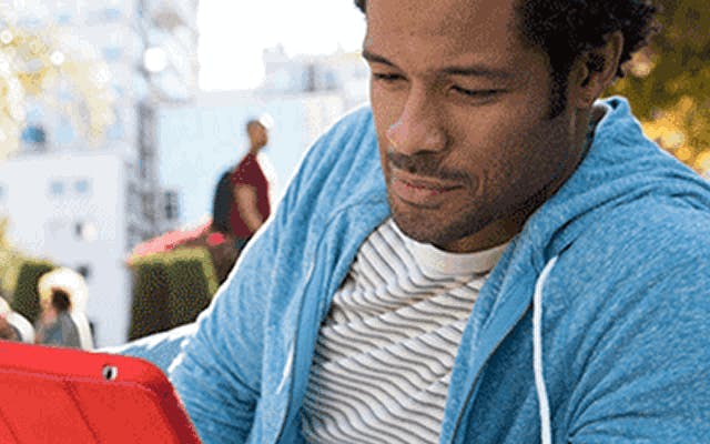 photo of man reading tablet