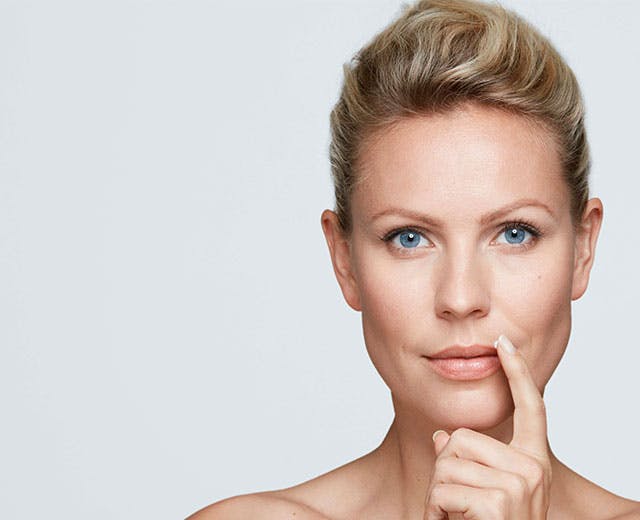 woman applying Zovirax cold sore cream