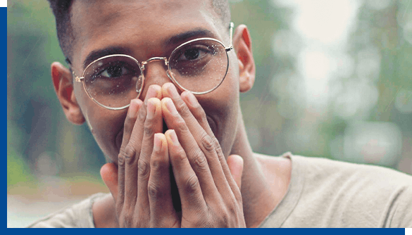 Man in glasses covering his mouth with hands to hide cold sores Man in glasses covering his mouth with hands to hide cold sores