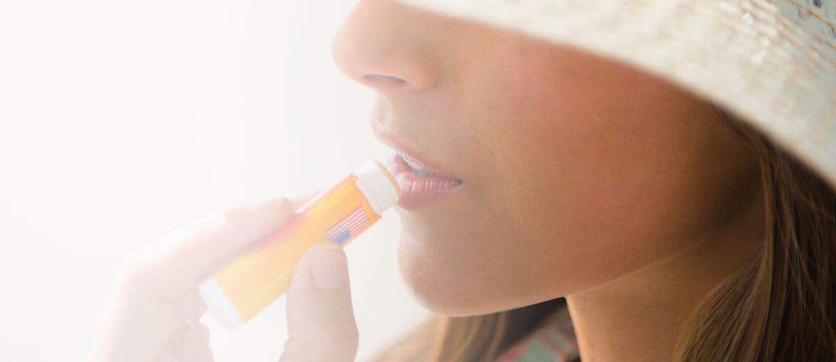 Woman applying lip balm Woman applying lip balm