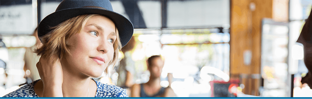 Woman wearing a hat in a shop